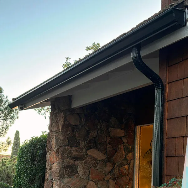 K-style gutter installed with corrugated downspout