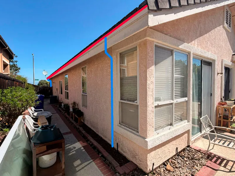 Colored line overlays indicating proposed new gutters (red line) and a vertical downspout location (blue line)